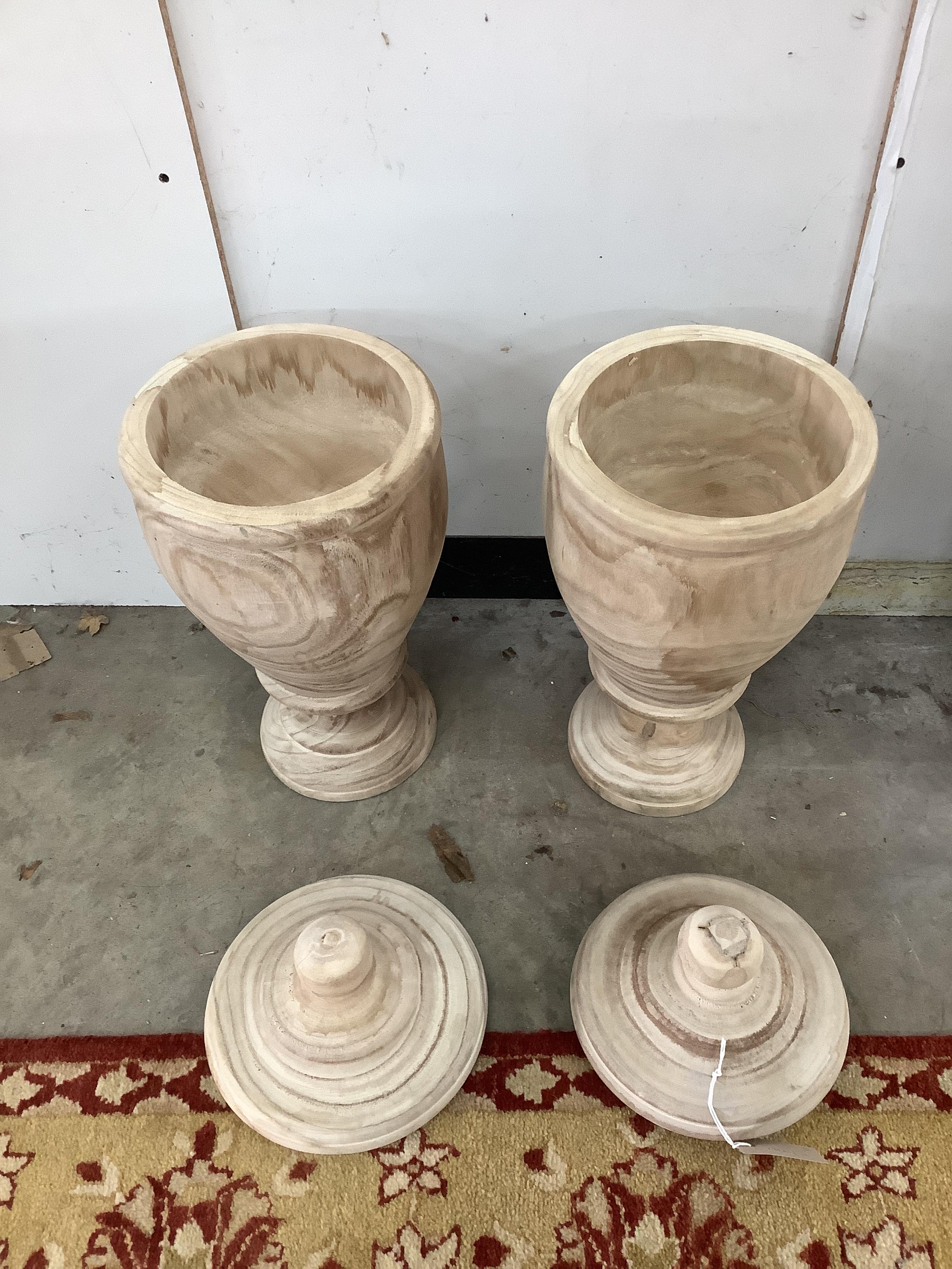 A pair of modern turned wood lidded urns, height 55cm